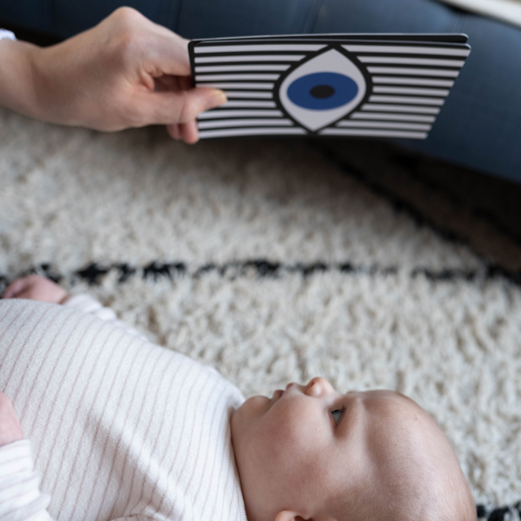 image of baby staring at bold eye print sensory flashcard