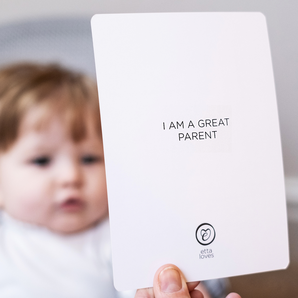image of baby staring at sensory flashcard, picture shows affirmation on the back saying i am a great parent