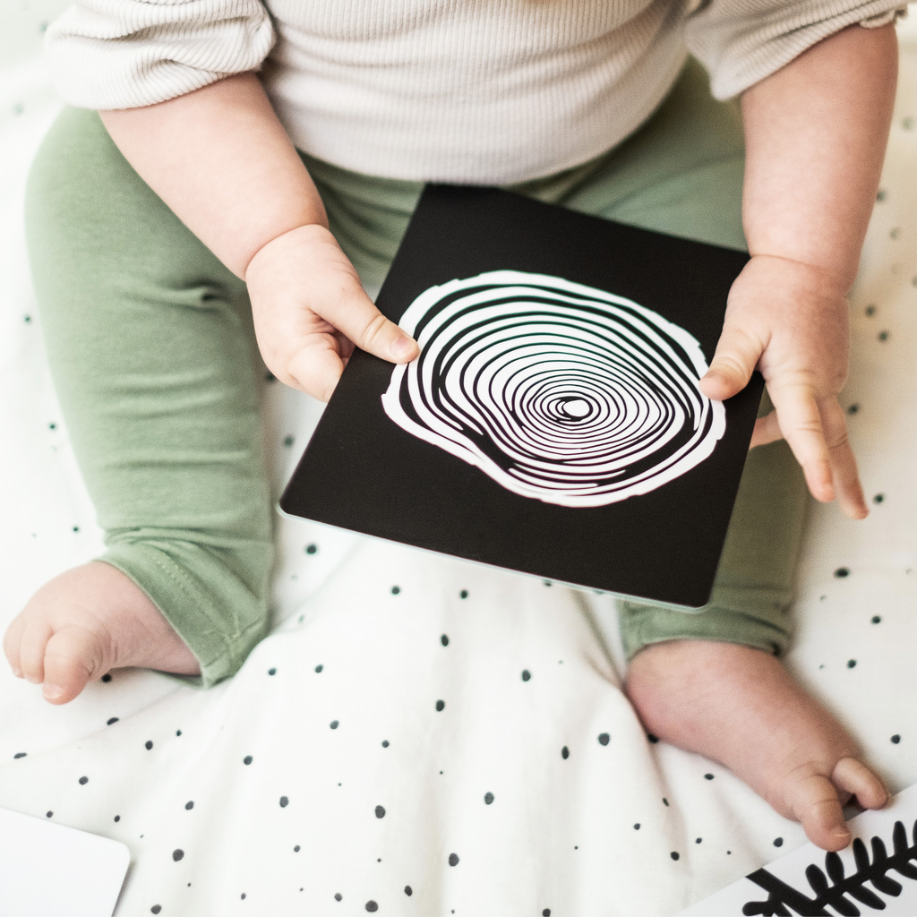 image of baby staring at bold tree ring print sensory flashcard