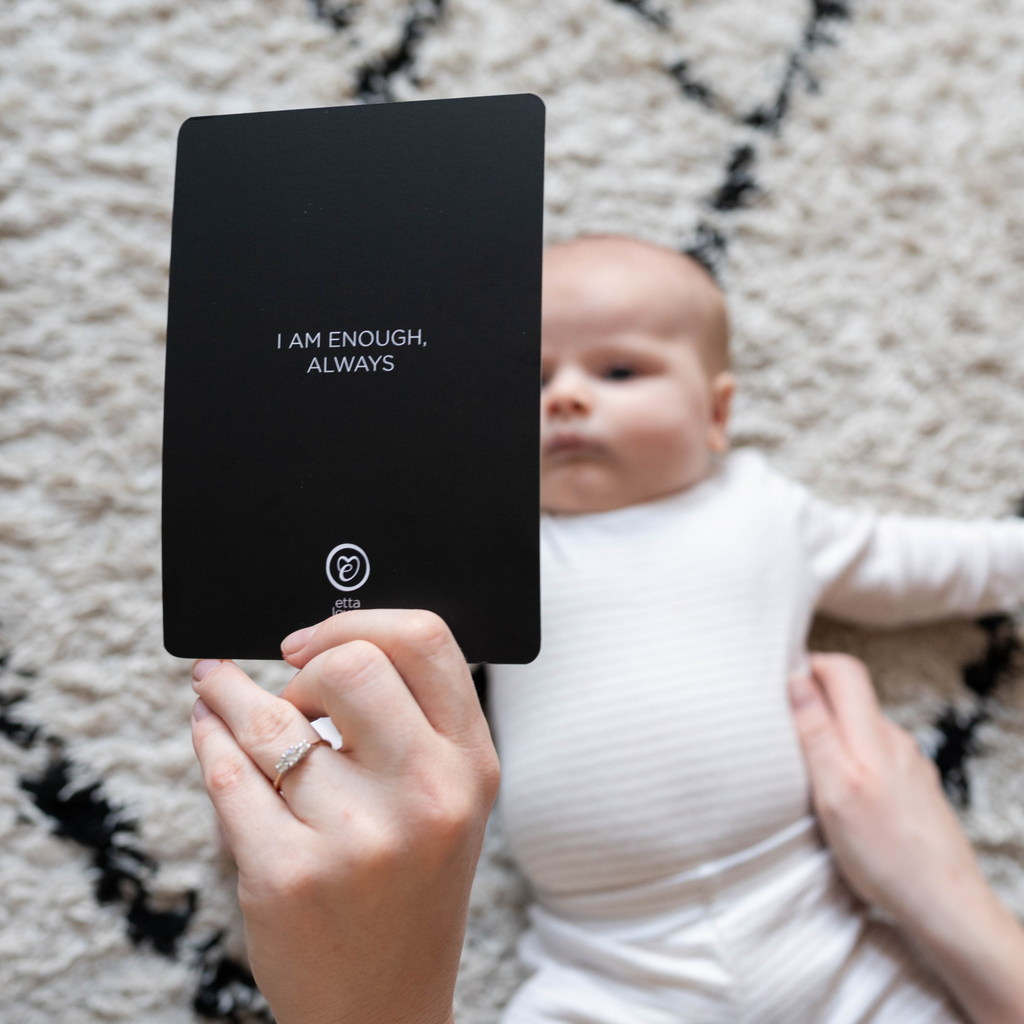 image of baby staring at sensory flashcard, showing parent affirmation reading i am enough, always
