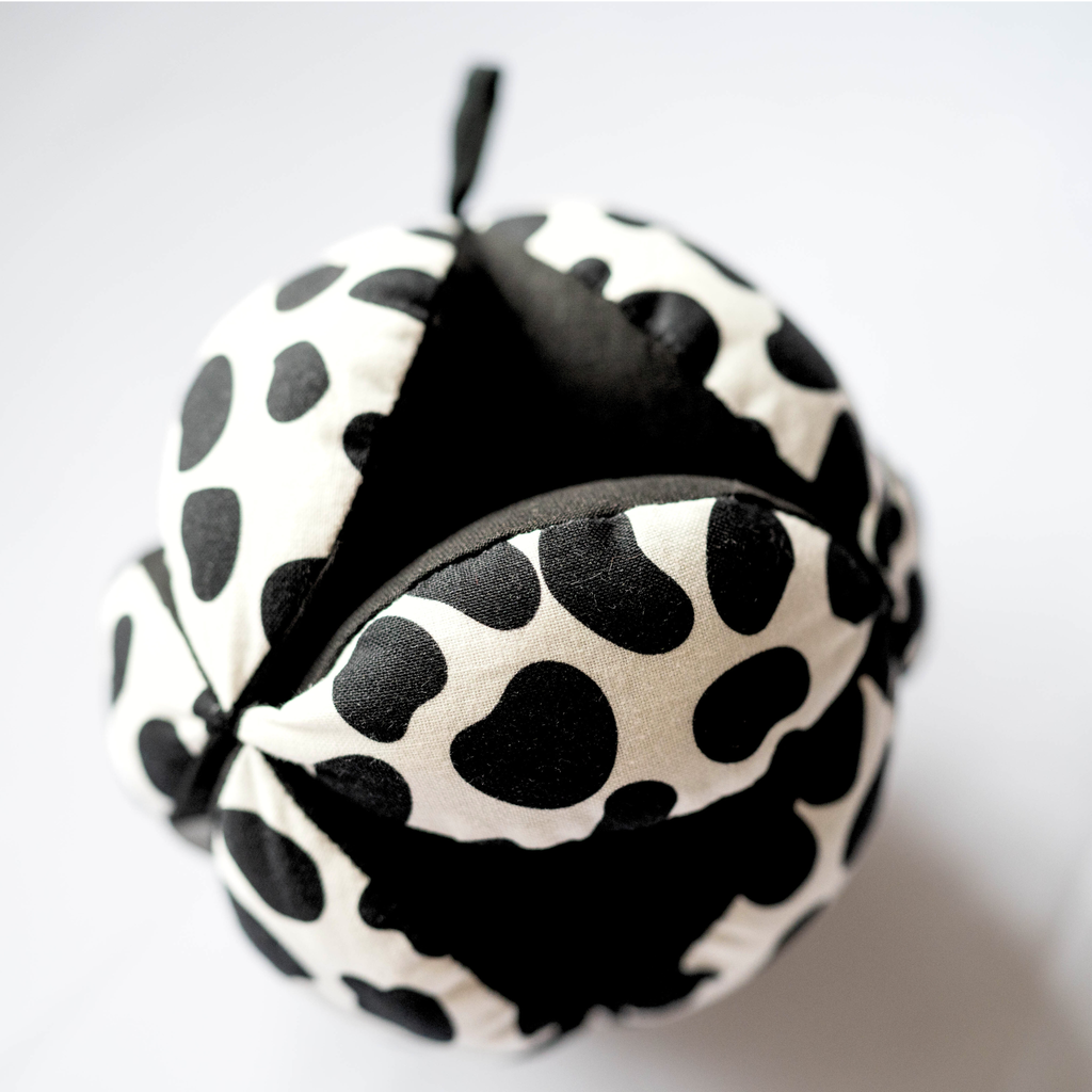 a sensory grasp ball from the top down in dalamatian print black and white fabric